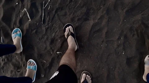 Leg Shot of Three People Walking on the Beach Dark Sand Stock Video Footage 1080 Stock Footage 317106441