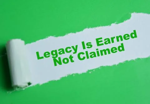 Legacy is earned not claimed text written in torn paper. Stock Photos