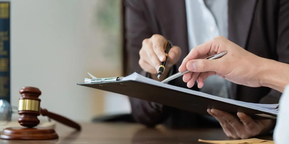 Legal Advice. Lawyer explaining documents to client during consultation. Stock Photos