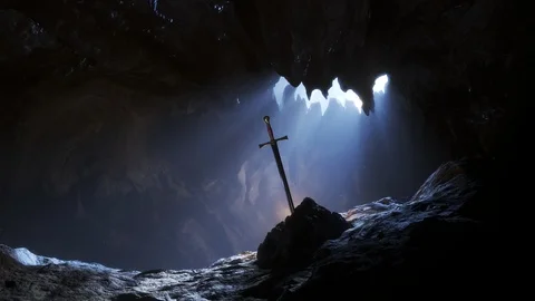 Legendary sword, Excalibur stuck in the stone in the dark cave with sunlight Stock Footage