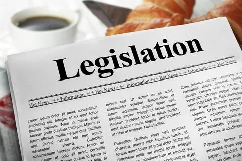 Legislation in newspaper layout on a breakfast table with a blurry cup of c.. Stock Photos