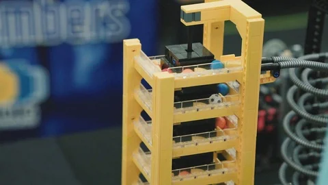 LEGO build of a elevator moving multiple tiny balls into a slide | Video stock 124032401