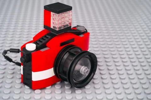 Lego camera on gray baseplate background. Stock Photos