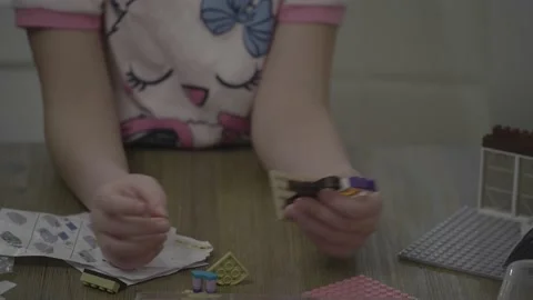 Lego, a kid's hands assembling lego pieces (variant). Stock Footage 146238103