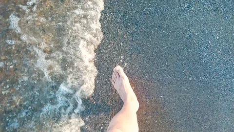 Legs are on the seafront. Feet on the beach Stock Footage 95496984
