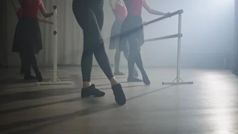 Legs of a ballet group practicing ballet moves at the barre. Stock Footage 240303345