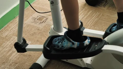Legs of a boy exercising on a walking machine during physical rehabilitation Stock Footage 256068259