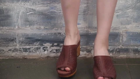 Legs in brown clogs Stock Footage 161270562