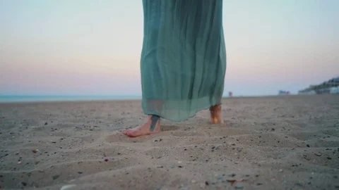 Legs of caucasian girl with flash tattoo, wearing green long dress and silver Stock Footage