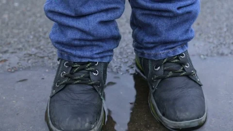 Legs of a child in a puddle Stock Footage 84085771