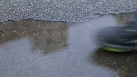 Legs of a child in a puddle Stock Footage 84085838