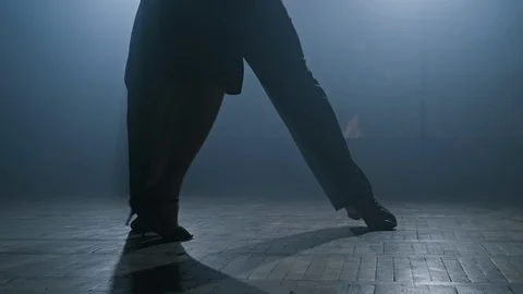 Legs of couple dancing tango in dark smoky studio in slow motion in 4K, UHD Stock Footage 124518544