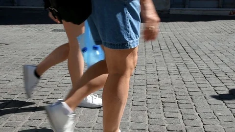 Legs of a couple walking while carrying bottles of water Stock Footage 113011465