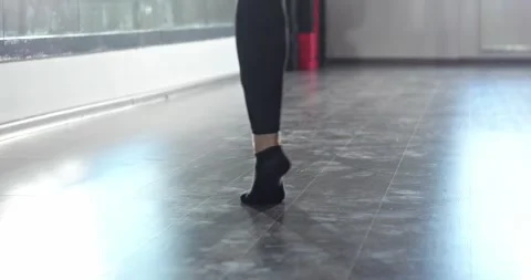 Legs of a dancer practicing a dance in front of a mirror wall in a studio. Stock Footage 280479690