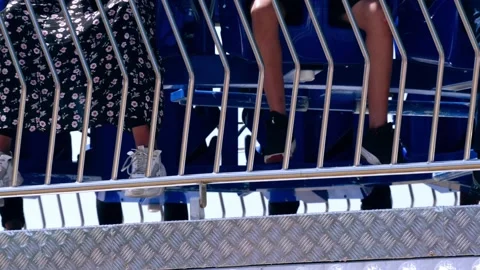 Legs dangle on fairground ride at fun fair Stock Footage 213216721