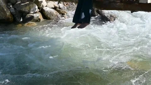 Legs Dangles Over Rushing Mountain River Water Video stock 340277871