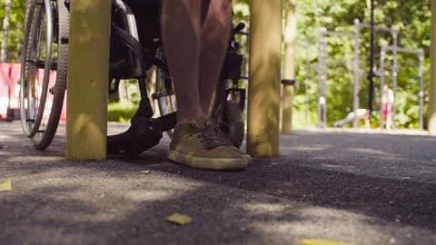 Legs of disable man sitting down in a wheelchair Stock Footage 93812661