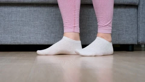 Legs doing exercises lifting on toes close-up, home workout concept. Stock Footage 322158265