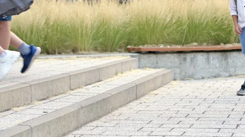 Legs of elementary school students jumping up the stairs in the school yard. Stock Footage 238441507
