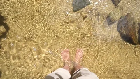 Legs in flowing clear water Stock Footage