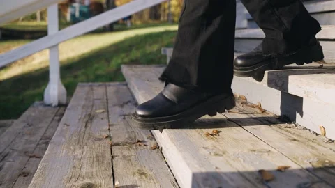 The legs of a girl walking down to the pier on a wooden ladder Stock Footage 219475191