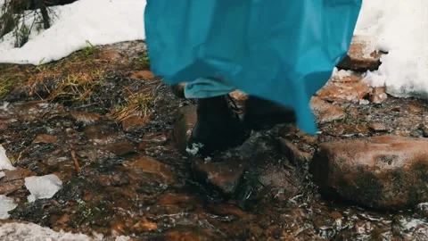 Legs of a group of tourists through a stream, climbing the mountains. Close-up Stock Footage 238859549
