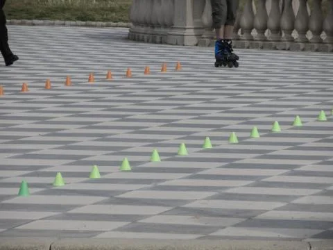 Legs of guy on inline skates . Inline skater and slalom cones Stock Photos