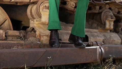 The legs of a guy in leather shoes beating the beat to the music Stock Footage 264511615