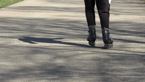 Legs of a guy riding an inliner Stock Footage 127783202