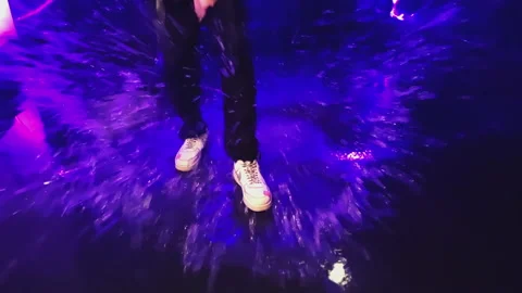 Legs of a guy in white sneakers close-up jumping in a small pool. Stock Footage 170626802