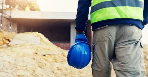 Legs, hardhat or worker walk on construction site for inspection, risk asse.. Foto stock