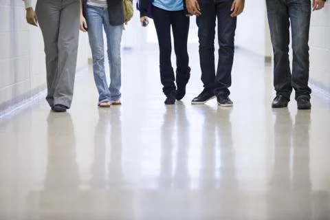 Legs of high school students walking down school corridor Stock Photos