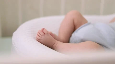 The legs of an infant in a cocoon Stock Footage 188649633