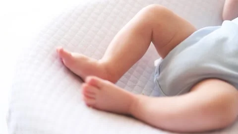 The legs of an infant in a cocoon Stock Footage 188652965