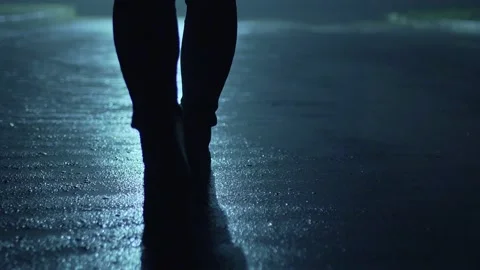 Legs of a man in backlight walking down the street at night. Stock Footage 198727181