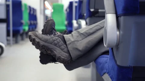 Legs of man dangle and block the passage of the rest of the people in the moving Stock Footage 169606270