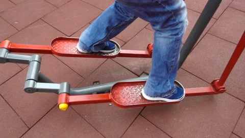 Legs of a man exercising on a simulator in slow motion Video stock 152964954