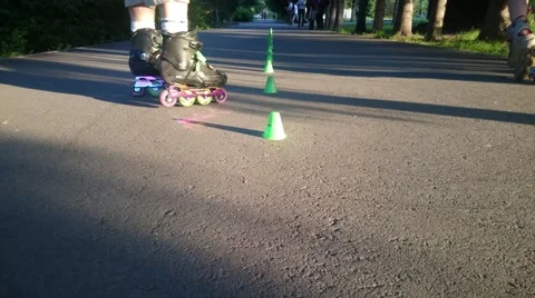 Legs of a man performs the trick on roller skates in city park. Stock Footage 51167634