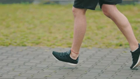 Legs of a man running along the path Video stock 160982748