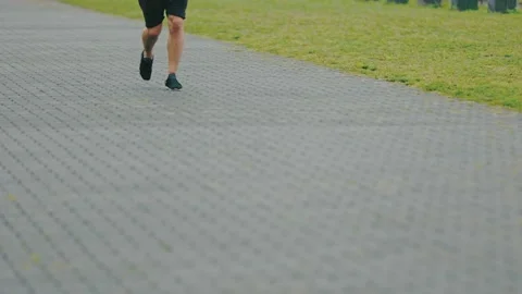 Legs of a man running along the path Stock Footage 161270942
