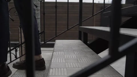 Legs of a man in shoes walking down the stairs Stock Footage 306147989