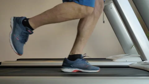 Legs of a man in sneakers running on an exercise bike in a sports center. Stock Footage 155131922