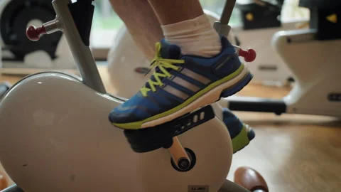 Legs of a man in sneakers while exercising on a stationary bike. Stock Footage 155132436