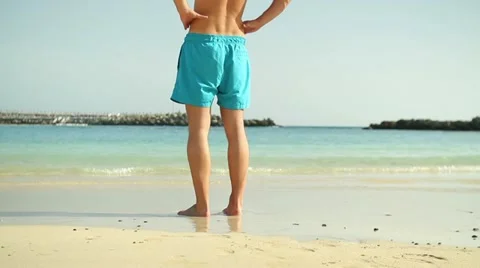Legs of man standing on the beach HD Stock Footage 10894439