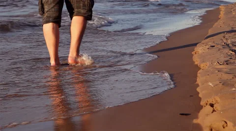 Legs of a man walking on the beach Stock Footage 27484650