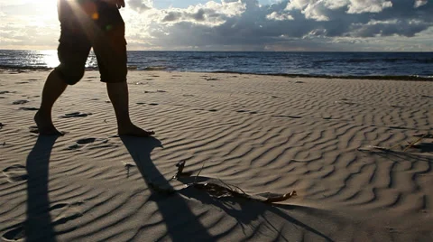Legs of a man walking on the beach Stockbeeldmateriaal 27484993