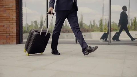 Legs of man walking down the street with bag Stock Footage 129552620