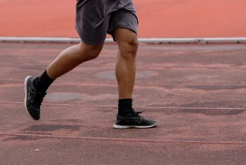 Legs of men jogging in a running track for good health Stock Photos
