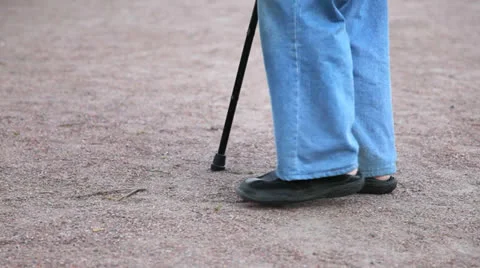 The legs of an old man go barefoot in the grass Stock Footage 24771530