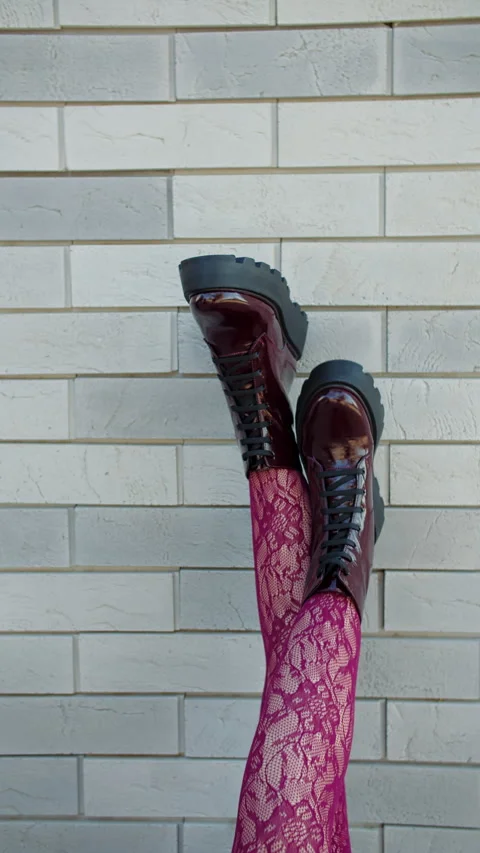 Legs in patterned tights and boots against wall Stock Footage 320788706